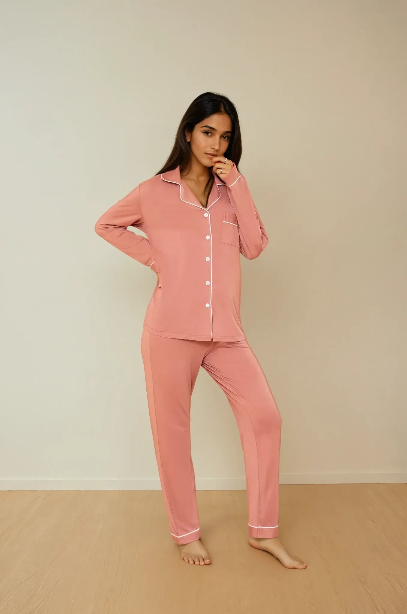 Front view of Prana Poshak's Cinnamon Pink bamboo pajama set, showcasing the button-up front and long sleeves