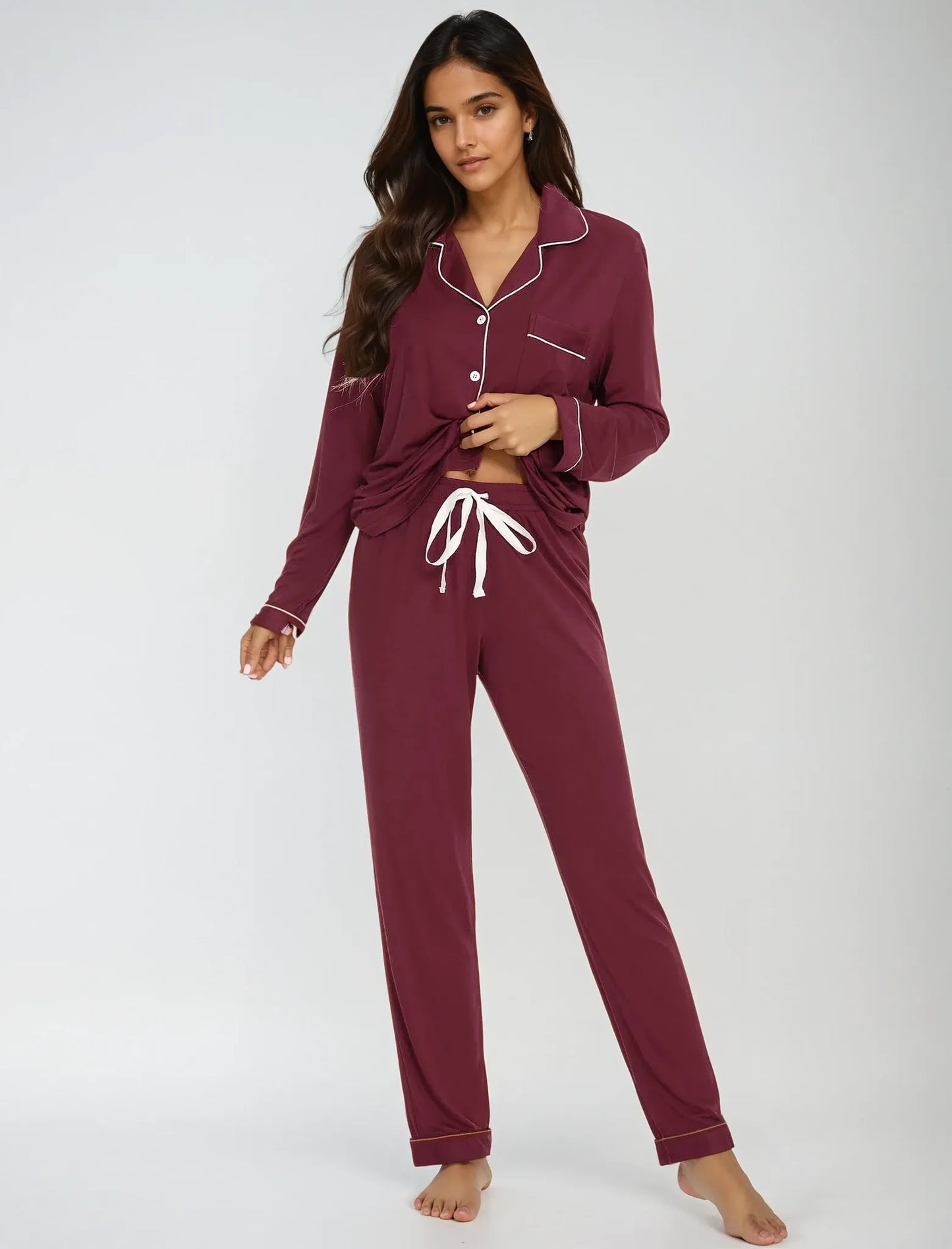Model in maroon bamboo pajama set with drawstring pants – playful pose showcasing comfort and stretch by Prana Poshak