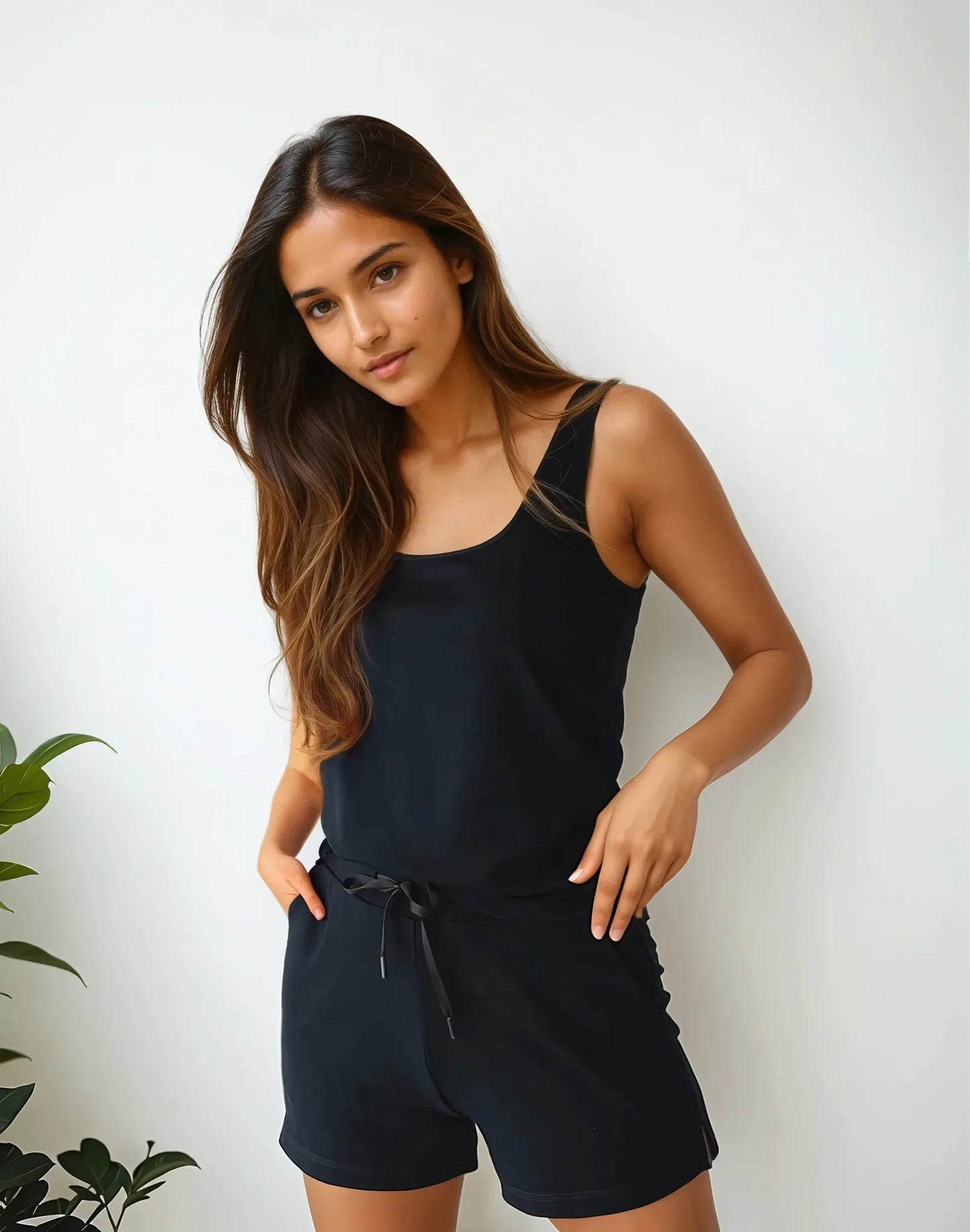 Front view of woman in Prana Poshak black bamboo tank top and shorts loungewear set with drawstring waist, looking casual and chic.