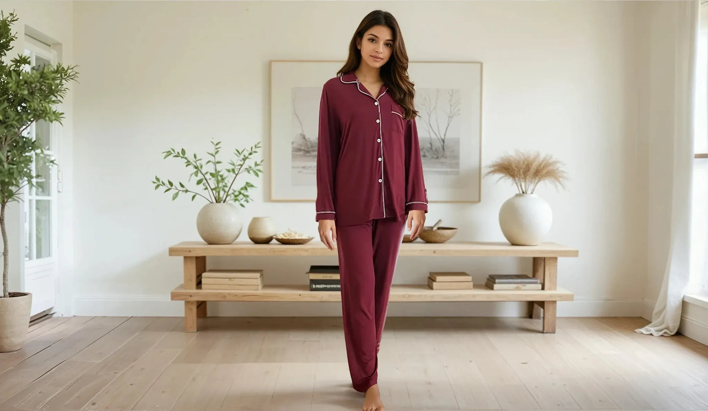 Woman walking in maroon bamboo prana poshak nightwear inside a light-filled, earthy living space.