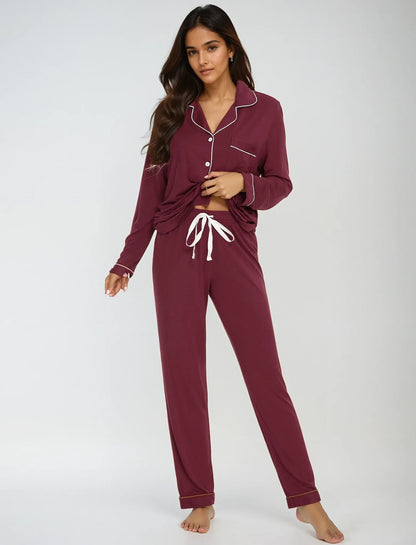 Model in maroon bamboo pajama set with drawstring pants – playful pose showcasing comfort and stretch by Prana Poshak
