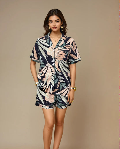 Front view of woman wearing Prana Poshak cotton modal nightwear leaf print shorts set with short-sleeve shirt