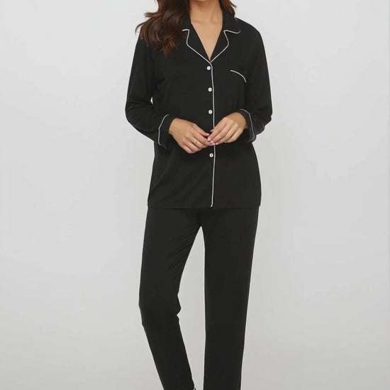 Model moving effortlessly in soft black bamboo pajama set with white piping – breathable and elegant nightwear by Prana Poshak